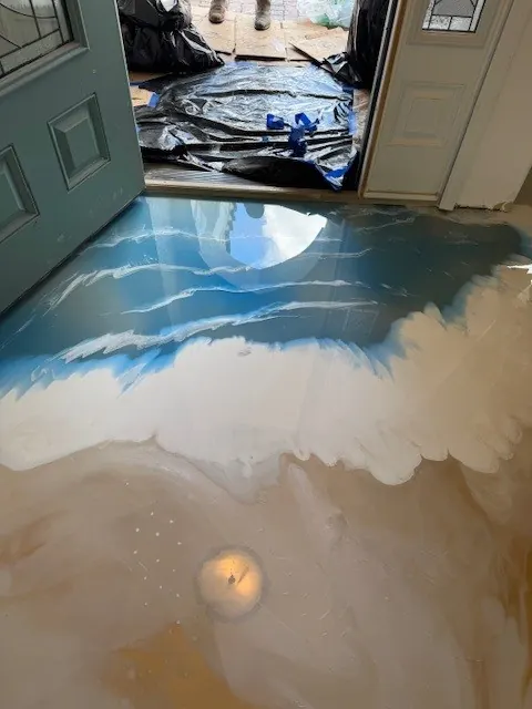 Blue and sand metallic epoxy floor resembling a shoreline