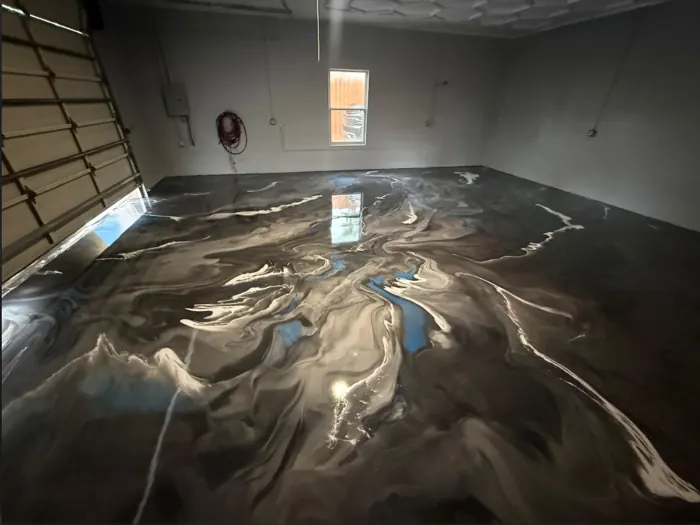 Charcoal and silver metallic epoxy garage floor with marbled veining